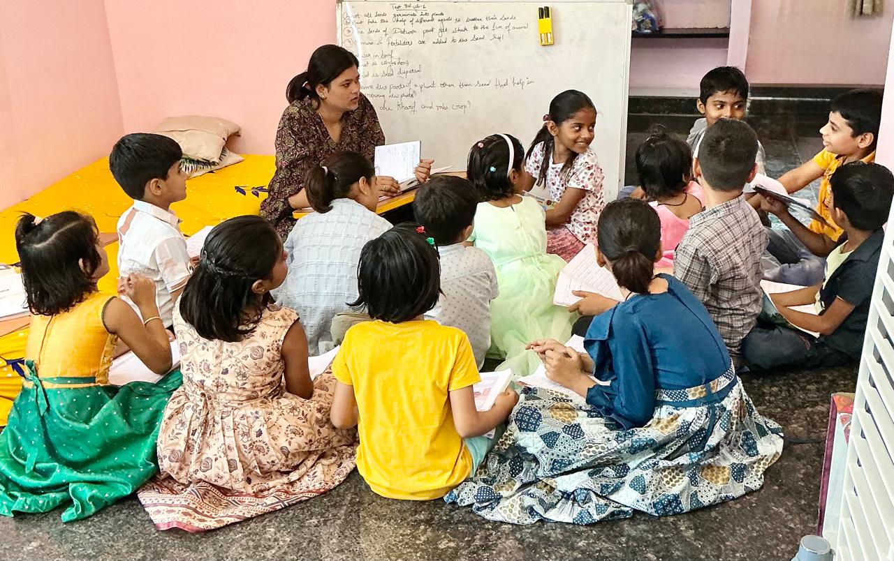 Modern classroom at Divya Classes with students attending lecture, whiteboard in background